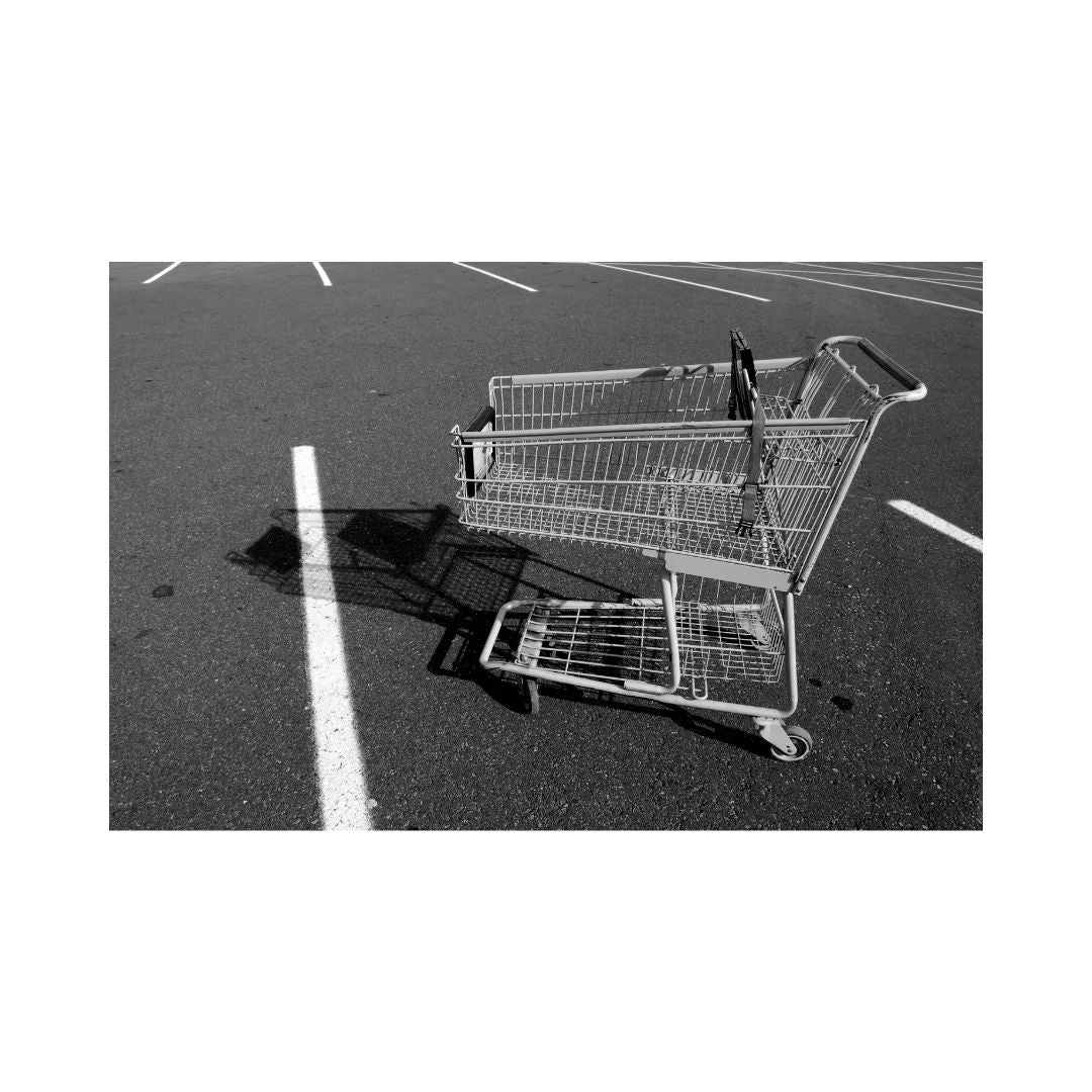 An image depicting a shopping cart with a black shadow on a parking lot surface, representing the theme of abandoned carts, which is related to the content of the e-book.