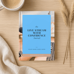 Journal titled 'Live Stream with Confidence' on a wooden surface with a cup of coffee and dried plants.