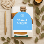 Book titled '52-Week Sobriety Journal' with a man's face on the cover, surrounded by leaves and a pen on a beige background.
