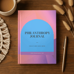 Philanthropy journal on a wooden surface with a pen and coffee mug.